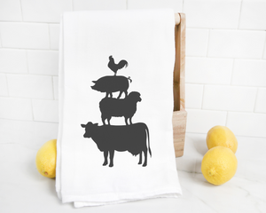 This Animal Stack Tea Towel features silhouettes of a cow, sheep, and pig. Perfect for adding a touch of rustic charm to your farmhouse decor or as an Animal Stack Tea Towel.
