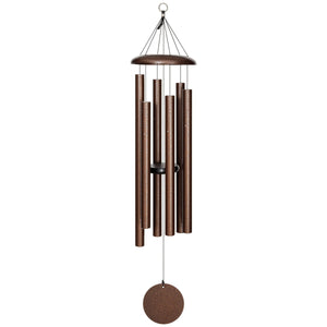 The Corinthian Bells® 44-inch Windchime, featuring six brown metal tubes hanging from a circular top, with a round clapper and sail at the bottom, adds depth and flair to any outdoor space.