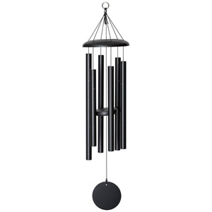 The Corinthian Bells® 36-inch Windchime, elegantly crafted in sleek black, features several cylindrical tubes hanging from a circular top with strings and a round disk at the bottom, making it perfect for enhancing your landscape design.