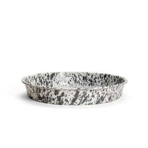 A round, shallow Splatter Enamelware Cocktail Tray/Deep Dish Pizza Pan featuring a speckled black and white pattern on its surface.