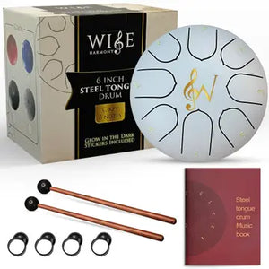The Steel Tongue Drum 6-Inch 8-Notes set includes mallets, finger picks, a music book, and comes in a box labeled “Glow in the Dark Stickers Included.” Featuring a beautifully crafted treble clef design, this percussion instrument is perfect for sound healing sessions.