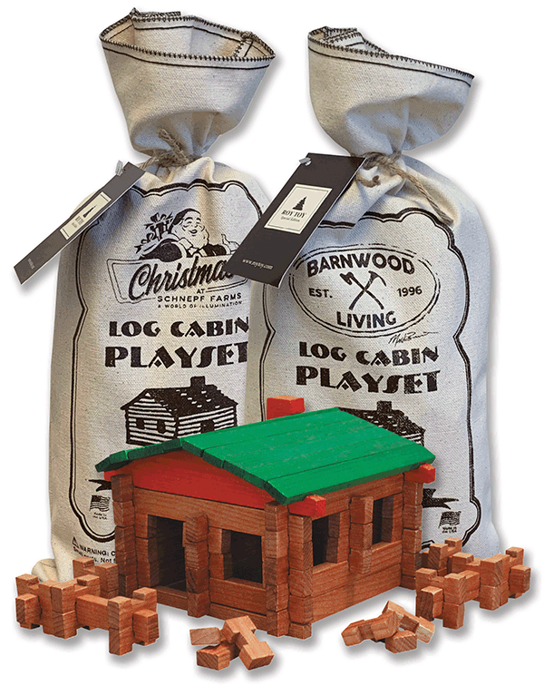 Two bags labeled "Roy Toy Log Cabin Canvas Bag" with one assembled wooden log cabin model and scattered all-wood pieces in front, showcasing this educational toy from Roy Toy Farm.