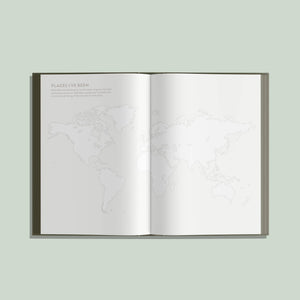 An open My Travel Journal displays a faintly outlined world map across two blank pages, with the title “Places I’ve Been” in the top left corner.