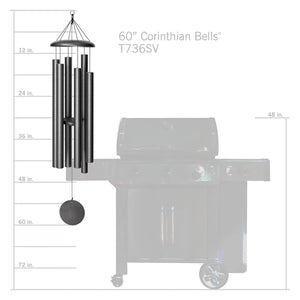 The Corinthian Bells® 60-inch Windchime is shown next to a grill for size comparison. Tuned to a harmonious major 7th chord, the chime features multiple vertical metal tubes suspended from a top ring and a circular weight at the bottom.