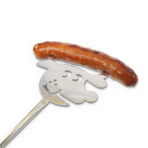 A grilled sausage resting on a metal spatula with a ghost-shaped cutout, isolated on a white background with a Combo Display - Corrugated.