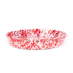 The Splatter Enamelware Cocktail Tray/Deep Dish Pizza Pan is a round, shallow enamel dish with a red and white speckled pattern, making it perfect for your gatherings.