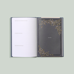 A Dad's Story memory book with a gold leaf design on it.