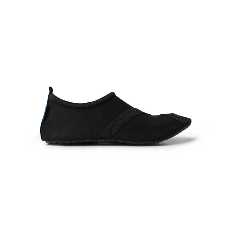 Women's Classic FITKICKS black minimalist shoe with a slip-on design and thin sole on a white background.
