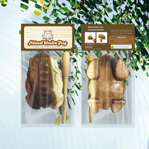 Image of packaging for a "Natural Wooden Frog." The front and back of the packaging are displayed, showcasing the wooden croaking frog percussion instrument, handmade in Thailand, along with its accompanying wooden stick.