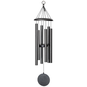 A small black Corinthian Bells® 30-inch Windchime hanging on a balcony.