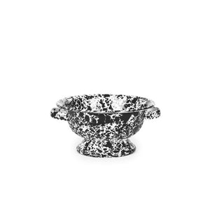 Splatter Enamelware Small Berry Colander with black and white speckles, two small side handles, and a pedestal base, showcases a classic enamelware design against a plain white background.