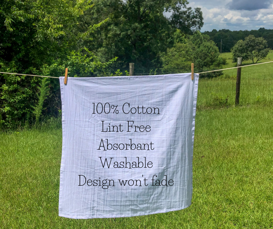 A Bless Your Heart Tea Towel hanging on a line in a field, exemplifying Southern pride.
