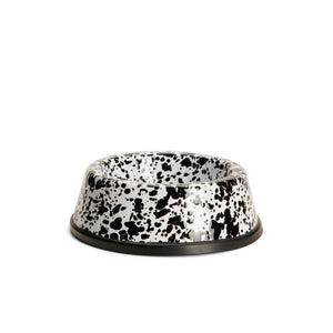 The Splatter Enamelware Small Pet Bowl features a black and white speckled design, a round shape, and a non-slip base. Shown on a plain white background, this non-toxic pet bowl is dishwasher-safe, combining style and practicality for everyday use.