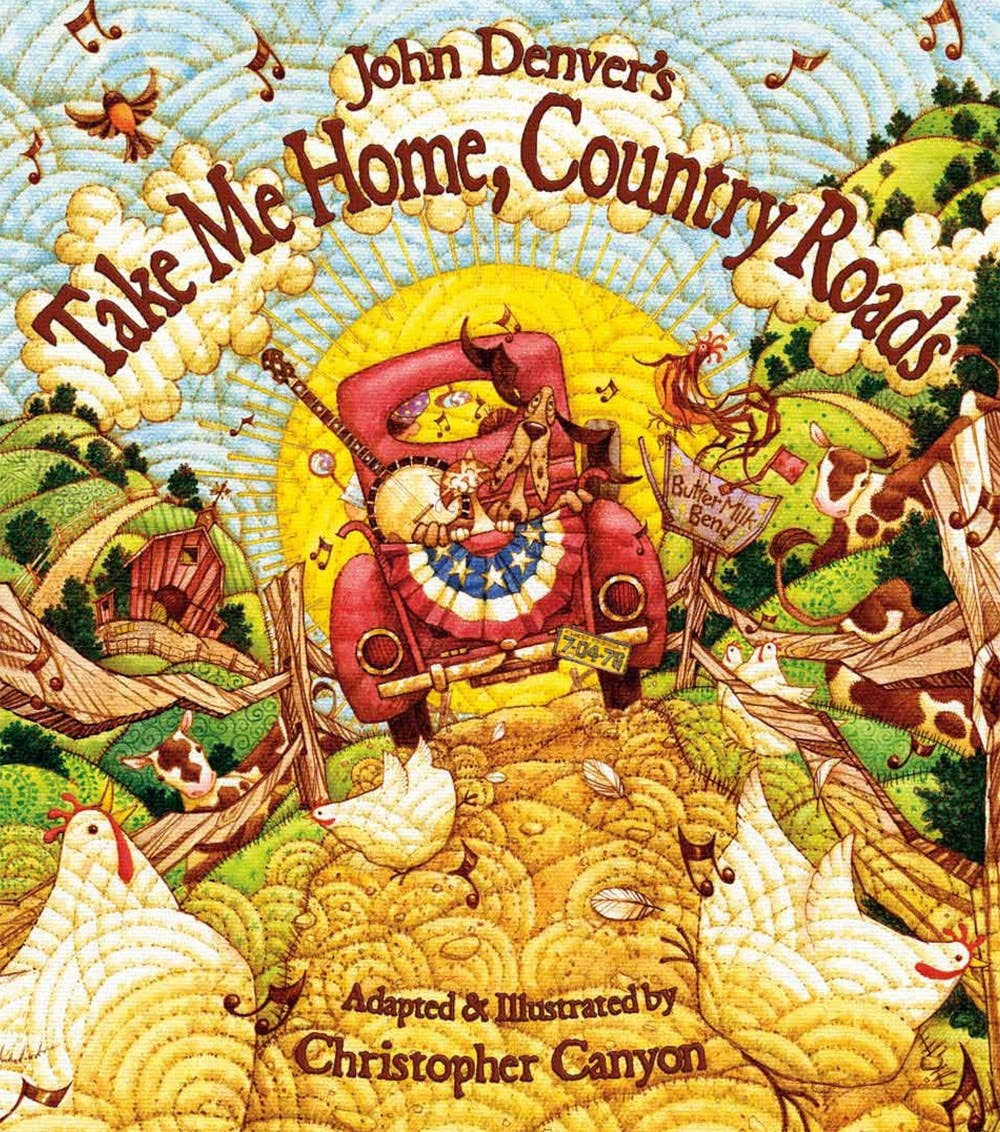 Illustrated cover of "John Denver's Take Me Home, Country Roads (TP)." A red truck with a driver, animals, and a road in a pastoral setting reminiscent of Appalachia. Adapted and illustrated by Christopher Canyon, this picture book beautifully captures the essence of home.