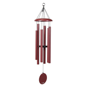 The Corinthian Bells® 36-inch Windchime, with red metal tubes hanging from a circular top and a round wind catcher, adds a charming touch to your porch rail and enhances your landscape design.