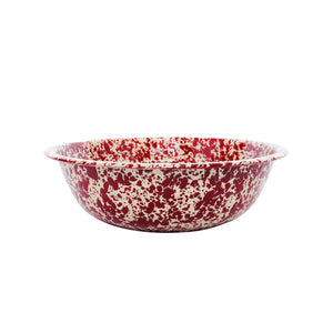The Splatter Enamelware Medium Basin, featuring a red and white speckled design, sits against a plain white background, highlighting its classic enamelware charm.