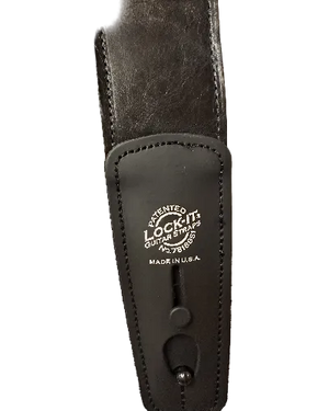 Close-up of the Lock-It Black Leather Strap, featuring "LOCK-IT Guitar Straps" and "Made in U.S.A." printed in white on the front.