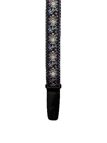 The Lock-It Blue Chill Retro Strap, featuring blue, yellow, and red decorative patterns with a black leather end, lies on a textured white surface.