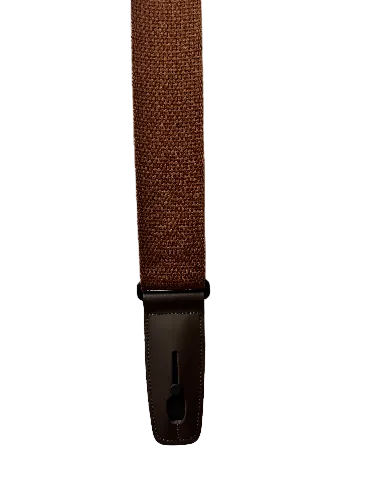 The Lock-It Brown Cotton Strap, featuring a rectangular brown leather buckle, is displayed on a textured white surface.