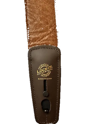 Close-up of the Lock-It Brown Leather Strap, highlighting its locking mechanism and gold-embossed "LOCK-IT Guitar Straps, Made in U.S.A." logo.