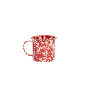 The Splatter Enamelware 12 oz Mug, featuring a red and white speckled design and convenient handle, is shown against a plain white background—perfect for entertaining guests with style.