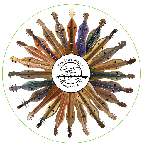 The Dulcimer Shoppe Circle Magnet features a circular arrangement of mountain dulcimers radiating outward from a central logo that reads “Dulcimer Shoppe, Mountain View, AR.”.