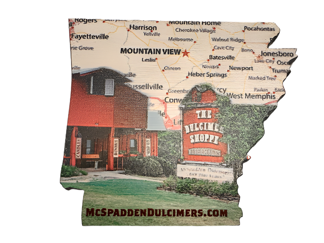 The Arkansas Wooden Magnet features a cutout of Arkansas with a map background and The Dulcimer Shoppe building in Mountain View. "MCSPADDENDULCIMERS.COM" appears at the bottom—perfect as an Arkansas or Mountain View souvenir.