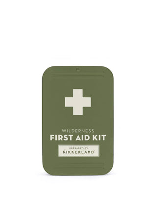 Green Wilderness First Aid Kit with the inscription "wilderness first aid kit" and a white cross, labeled by kikkerland, featuring a durable metal casing.