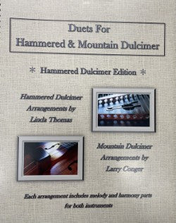 Cover of the sheet music for "Duets for Hammered & Mountain Dulcimer" by Linda Thomas and Larry Conger, showcasing striking images of hammered and mountain dulcimers. It includes a CD to enhance your musical experience.