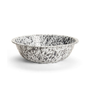The Splatter Enamelware Medium Basin is a round, shallow bowl with a white base and black speckled pattern, featuring a classic enamelware porcelain finish, displayed on a plain white background.