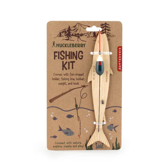 Huckleberry Fishing Kit packaging featuring a wooden fishing pole, fish-shaped holder, line, bobber, weight, and hook; illustrated with a mountain and campfire popcorn popper background.
