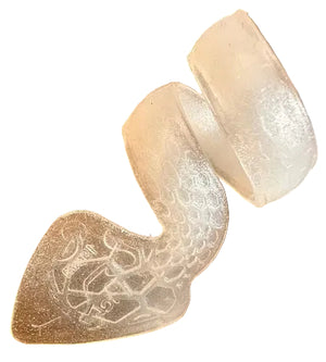 A translucent, flexible SnakePick with a textured pattern rests on a wooden surface.