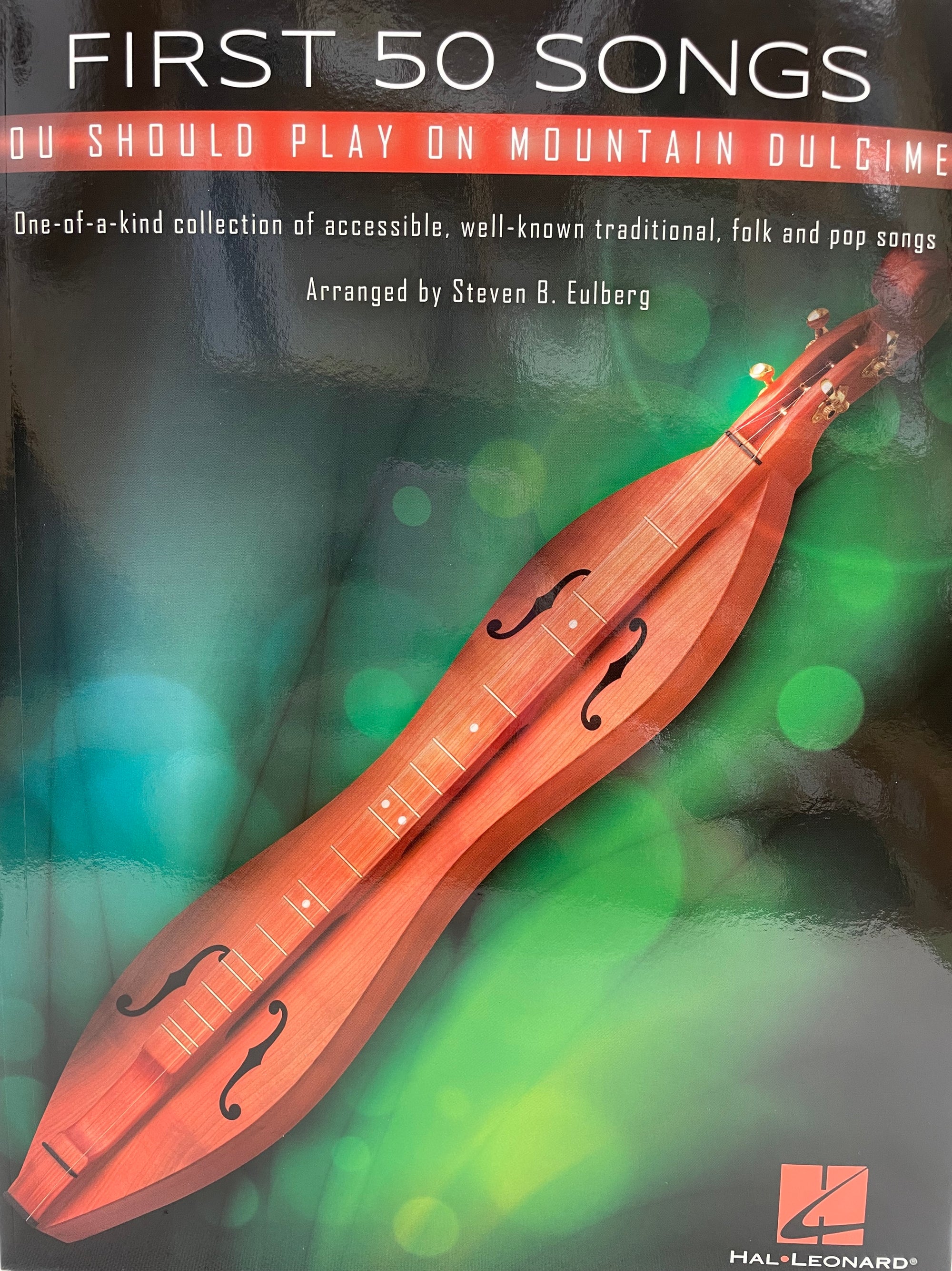 Cover of the music book 'First 50 Songs You Should Play on Mountain Dulcimer by Steven B. Eulberg', featuring a red dulcimer and green abstract background.