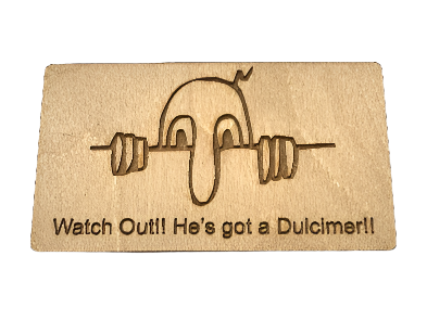 Kilroy Dulcimer Wooden Magnet featuring an engraved cartoon face holding a bar and the phrase "Watch Out!! He’s got a Dulcimer!!".