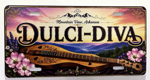 Introducing our new Vanity Plates—a decorative license plate designed to capture the spirit of Mountain View, Arkansas. Featuring vibrant images of mountains, flowers, and a mountain dulcimer, this plate proudly displays “Mountain View, Arkansas” and “Dulci-Diva” in bold letters. It’s a fitting tribute to the town’s rich folk music heritage.