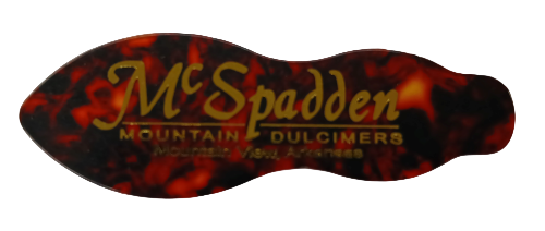 The NEW! McSpadden Dulcimer Pick is a novelty tortoise shell plastic pick with "McSpadden Mountain Dulcimers, Mountain View, Arkansas" printed in yellow.