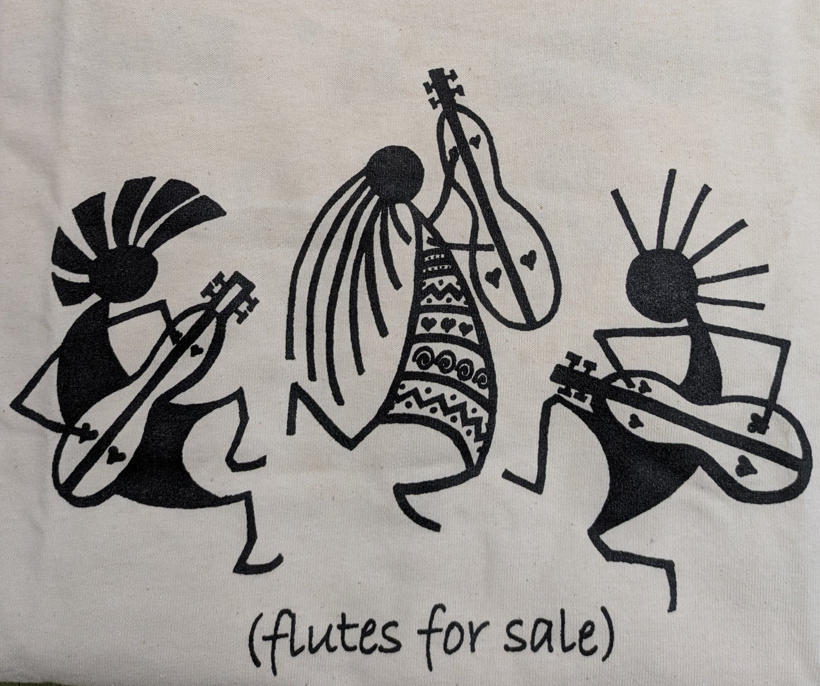 Three black-and-white Kokopelli figures play flutes above the text "(flutes for sale)"—ideal for the Long Sleeve T-shirt - Kokopelli Design.