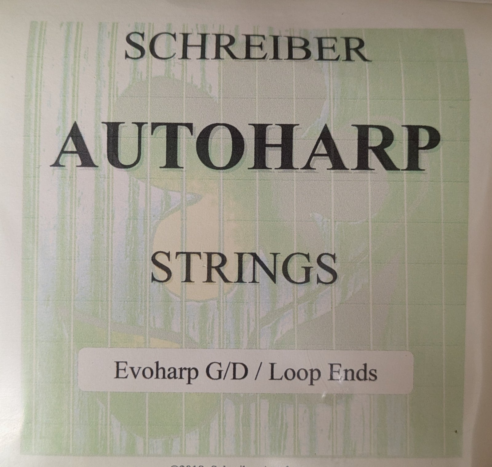 Label for Autoharp String Set-Evo G-D Loop Ends shown on a green patterned background.