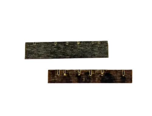 Two Micarta Bridge and Nut Sets, each featuring a row of small metal hooks, are placed parallel on a plain white background—ideal dulcimer accessories for organizing picks or referencing McSpadden fretboards and fretboard width during instrument maintenance.