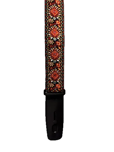 A close-up of the Lock-It Persian Retro Strap, showcasing its black base with a red and gold floral pattern and black leather ends.