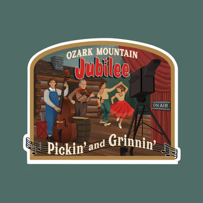 Illustration of a band playing in a log cabin with "Ozark Mountain Jubilee: Pickin' and Grinnin'" sign, featuring cameras and an "On Air" light, capturing the essence of The Scented Palette Candle: Pickin' & Grinnin'.