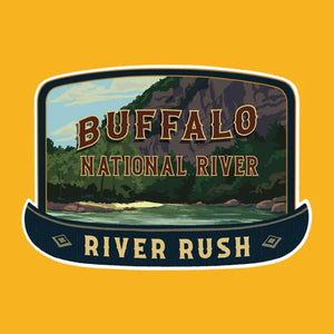 An illustrated logo for "The Scented Palette Candle River Rush," from the Ozark Collection, features a scenic river framed by majestic mountains and lush trees on a yellow background.