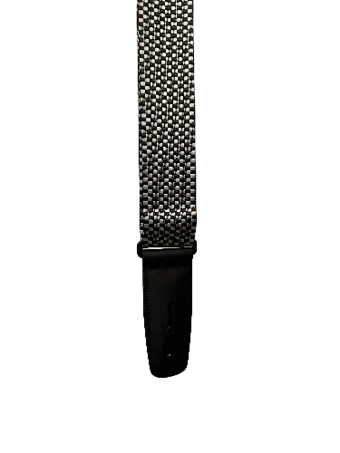 A vertical Lock-It Silver Checker Poly Strap with a black-and-white checkered pattern and black leather end tab is shown against a white background.
