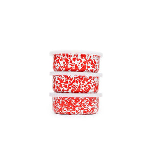 The Splatter Enamelware 3-pc Storage Bowl Set features three round containers with eye-catching red and white speckled patterns, each topped with a white lid and stacked neatly against a plain white background—a perfect, colorful addition to your serveware collection for stylish entertaining.