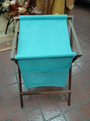 A turquoise, handmade fabric Sling Music Stand attached to a wooden folding music stand.