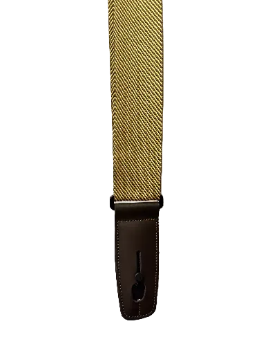 A close-up of the Lock-It Tweed Strap, featuring a tan and yellow herringbone pattern with a dark brown leather end piece.