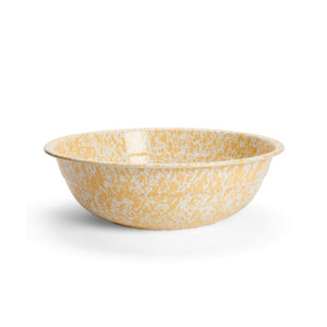 The Splatter Enamelware Medium Basin, a shallow, round bowl featuring yellow and white speckles and a durable porcelain enamel finish, is displayed on a plain white background.
