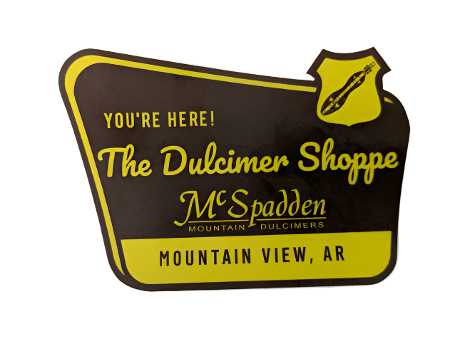 Add some flair to your water bottle or laptop with McSpadden Stickers featuring a brown and yellow "You're here! The Dulcimer Shoppe, Mountain View, AR" sign and dulcimer graphic.