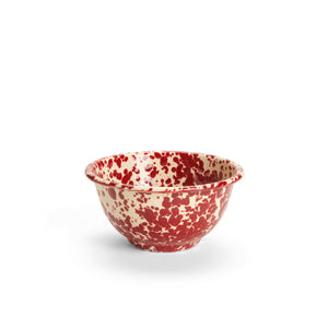 The Splatter Enamelware Small Footed Bowl, featuring a white base with a red splatter pattern on both the exterior and interior, is perfect for serving dip and is photographed on a plain white background.