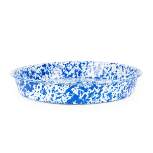 An oven-to-table deep dish pizza pan, with a vibrant blue and white splatter pattern on its exterior.